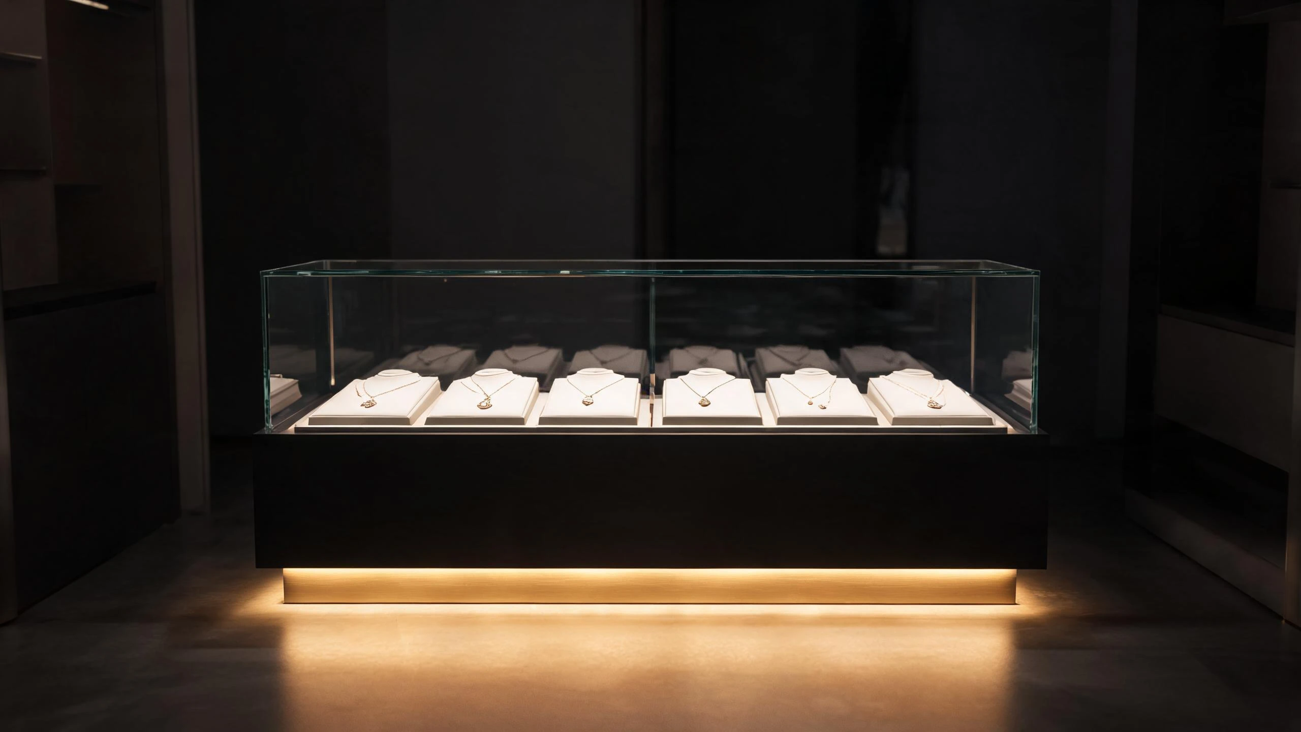 Jewelry display counter with illuminated LED base glowing beneath the cabinet