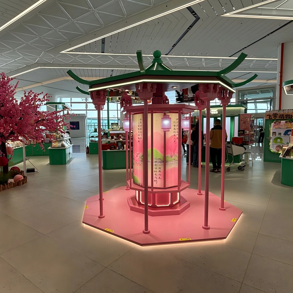 Pagoda-style pavilion entrance with terracotta warrior sculpture and pink flowering trees in a retail store interior design installation, emerald green and gold colour scheme