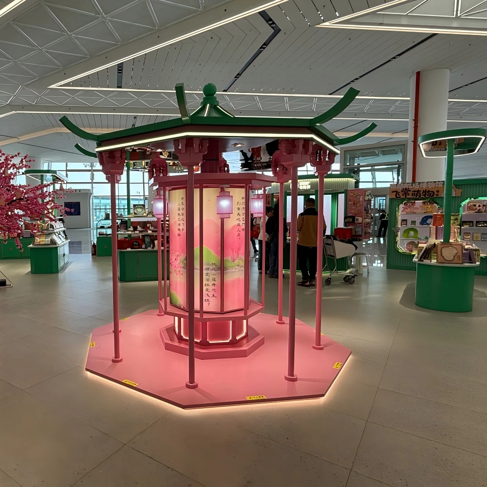 Wide-angle view of flowering tree centrepiece and pavilion displays in a retail store design installation, terminal retail island layout
