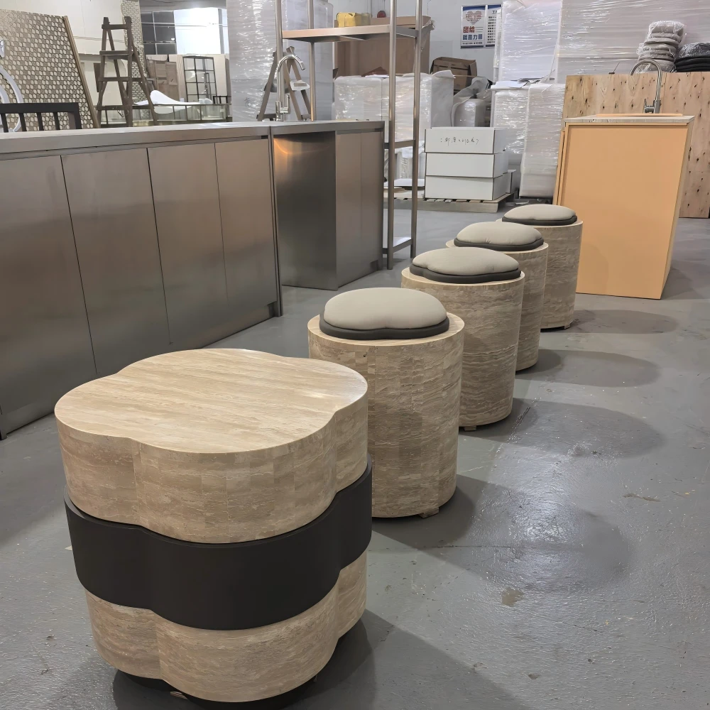 Round travertine-look bucket stool with grey cushion on its matching base, displayed before packing in this production sample
