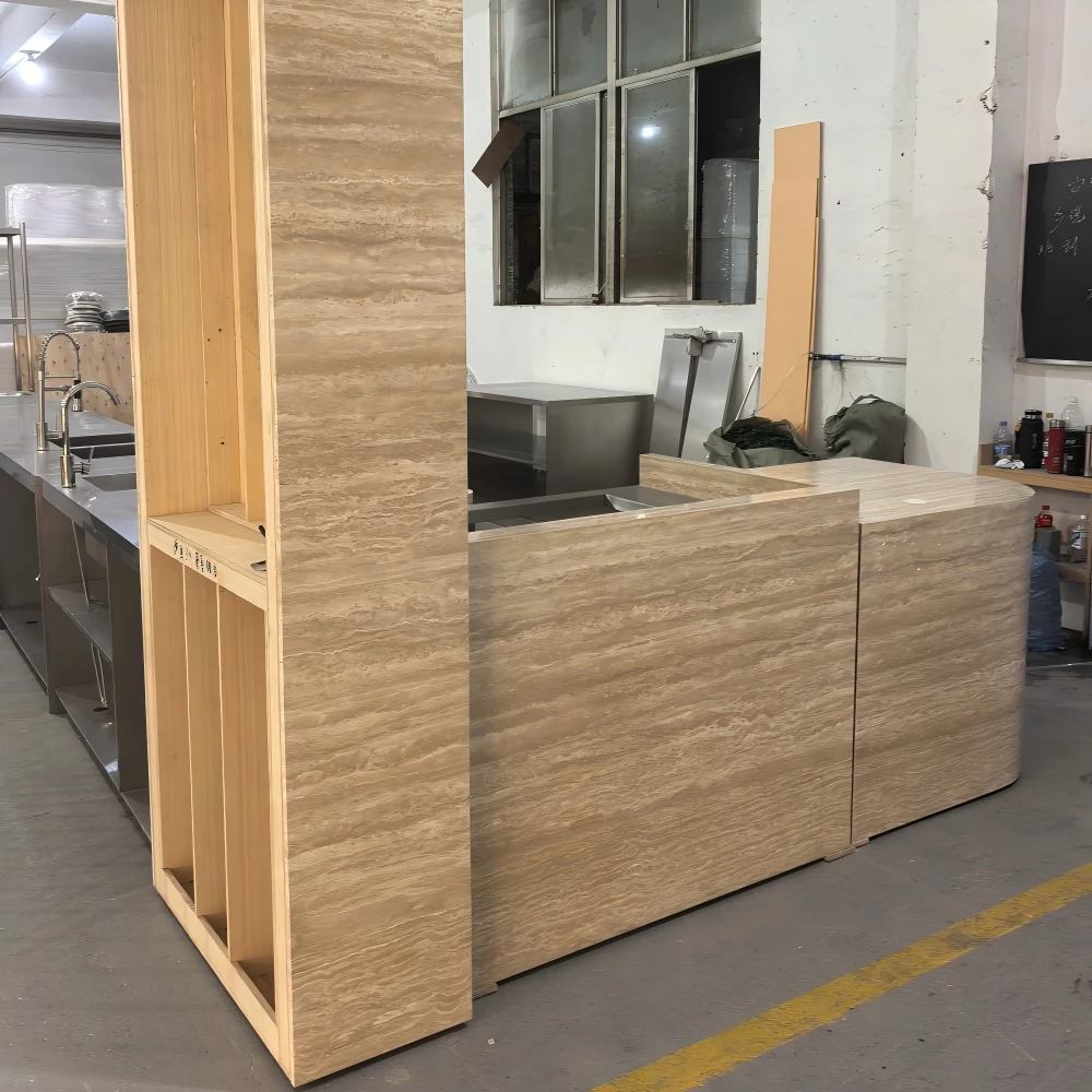 Peach-pink lacquer kitchen island with a marble-stone sink and curved cabinet body in a retail store fixtures production sample