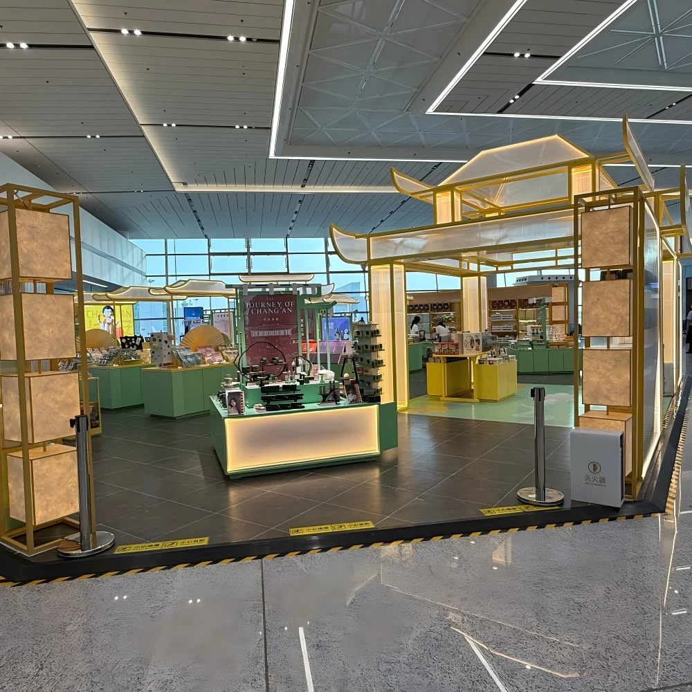 Wide-angle view of pavilion-style retail counters arranged under geometric ceiling baffles with natural daylight in a retail interior design live store