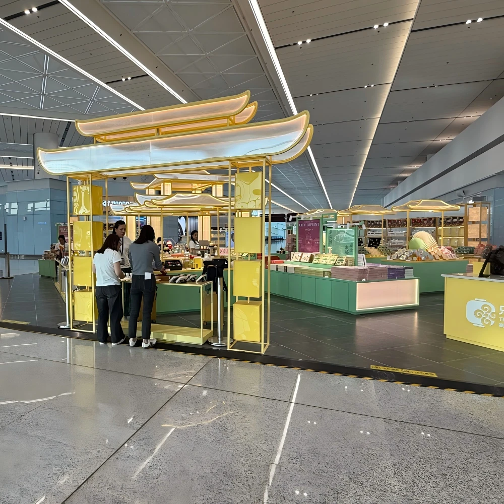 Cashier counter with traditional eave canopy and mint-green fascia in a retail display stand design airport island