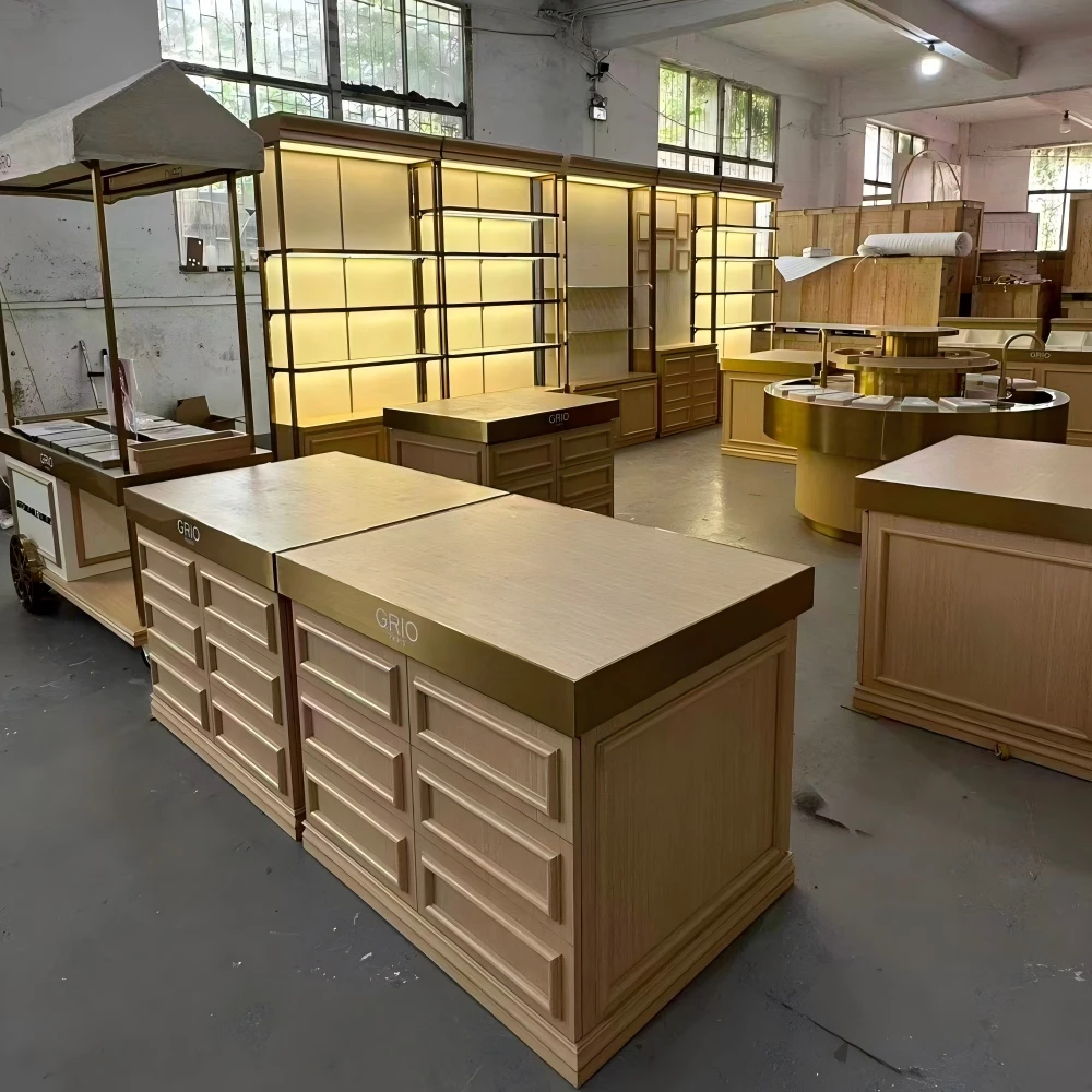 Full workshop view of a beauty retail store design production sample set including tall cabinets, circular island, mobile cart and cashier counters