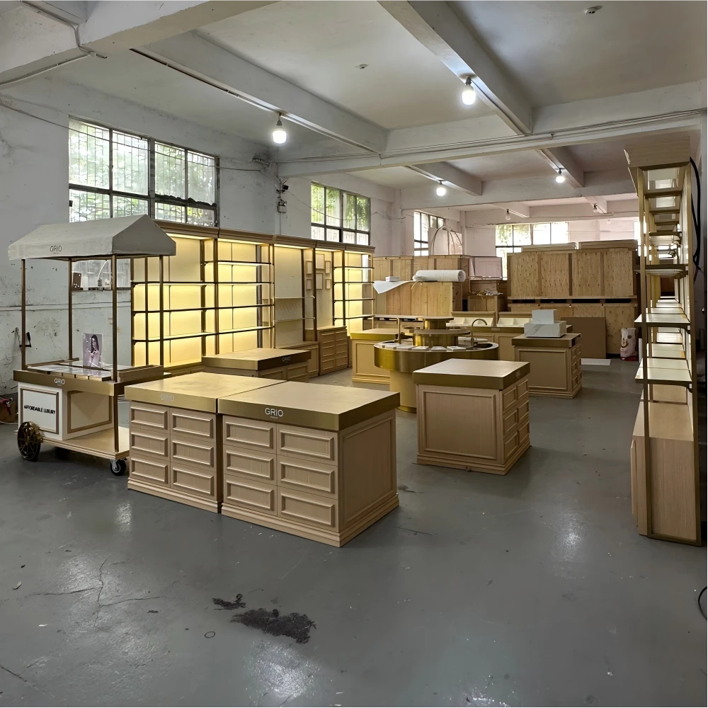 Mobile retail cart with canopy frame, gold-finish hardware and product display trays in a retail design and build factory sample