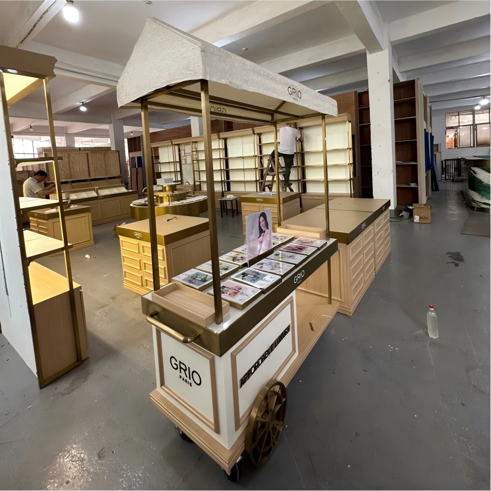 Row of tall display cabinets with integrated lighting and matching light-oak base in a retail store design factory sample