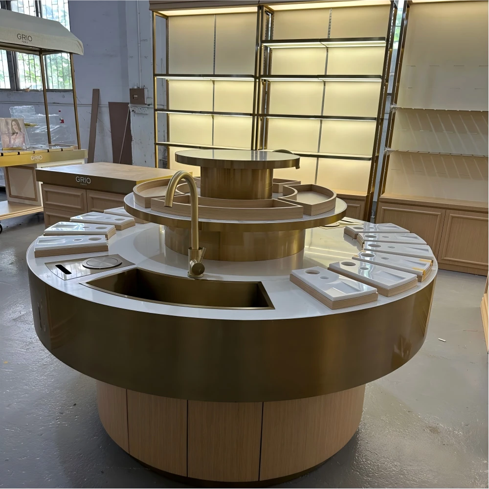 Long cashier counter with marble-look surface, lockable drawers and champagne-gold edge trim in a retail design and build factory sample