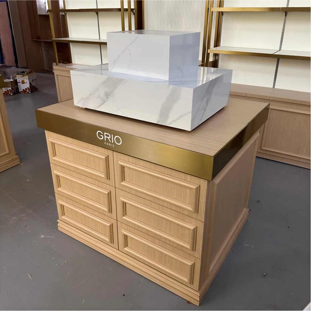 Extended cashier counter with partitioned service bays and matching light-oak cabinetry in a retail display stand design production sample