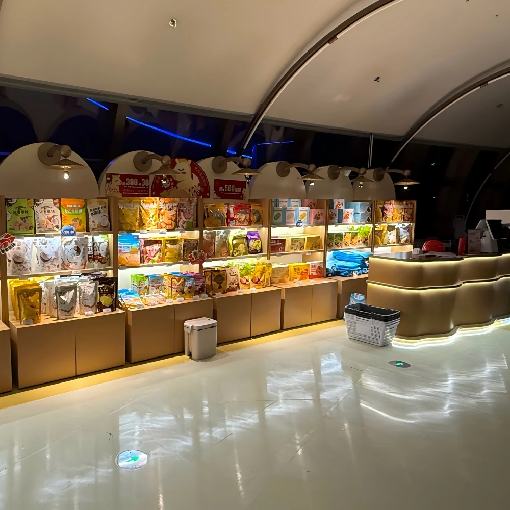 Retail store layout design with open-lit food shelves and warm wood cabinetry in a travel-retail live store