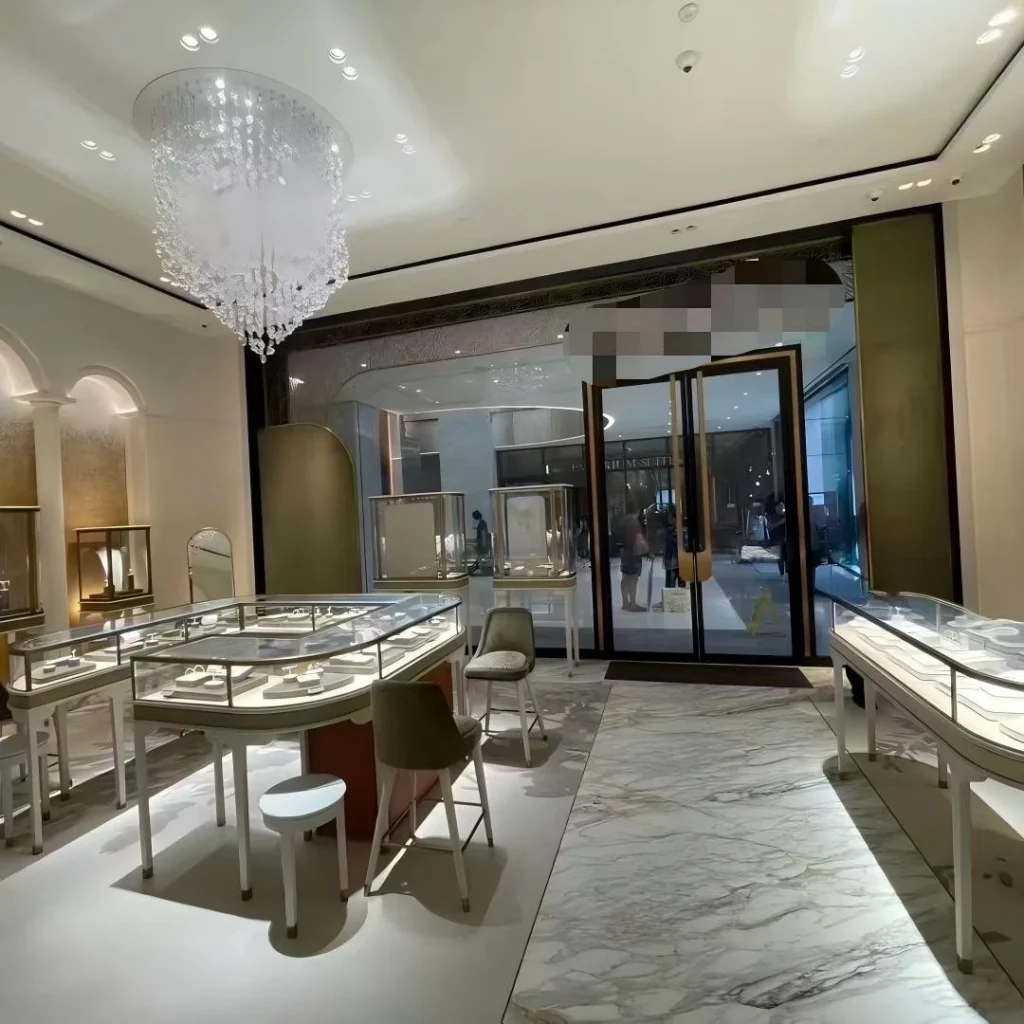 Arched wall niches and oval island counter with consultation seating in a custom jewelry boutique