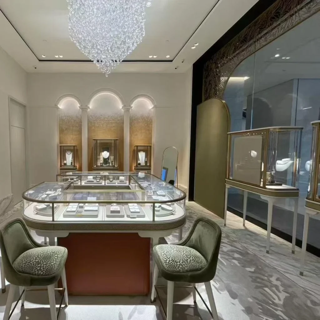 Curved glass counters and three arched jewelry niches under a crystal chandelier