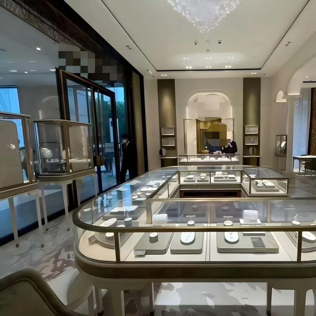 U-shaped jewelry island counter and arched niche wall in a luxury salon interior