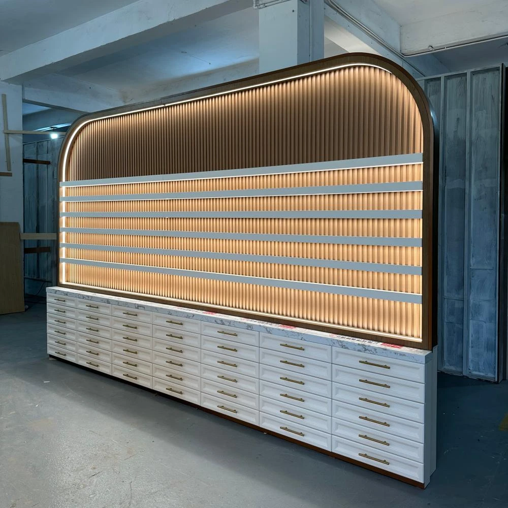 Arched fluted display cabinet with rose-gold handle drawers, sage-green LED-backlit panel and marble countertop, nail salon furniture production sample