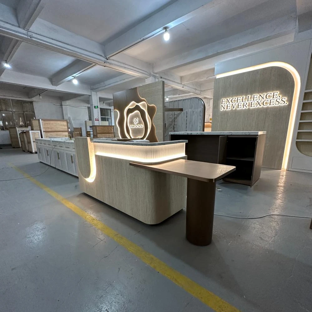 Scalloped marble reception counter with cream-and-sage cabinets and arched wordmark feature wall inside a nail salon interior design workshop sample
