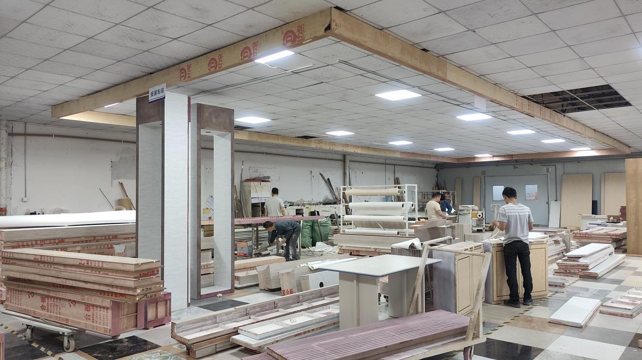 Workers assembling jewelry display case in factory
