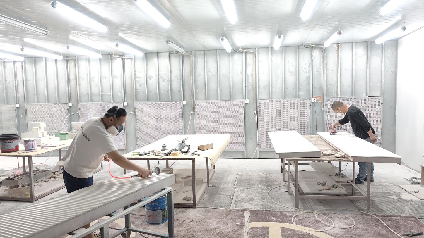 Worker polishing metal frame for jewelry display case