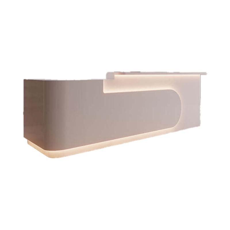 Reception Desk With Counter in white lacquer with S-curve front panel, embedded LED light strip and raised transaction counter on a pure white background