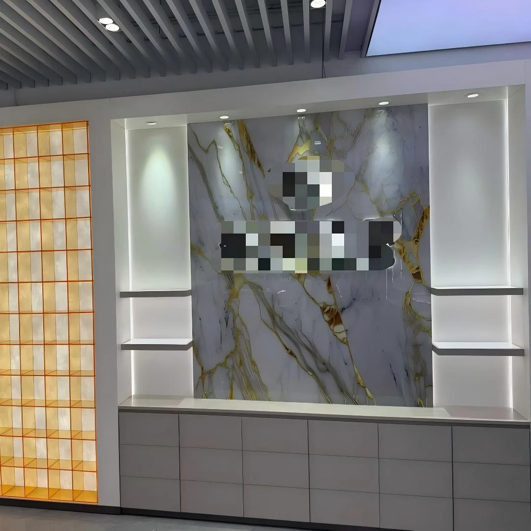 Cosmetic display case wall units with backlit ledges in white frames over a grey drawer bank, set against a Calacatta-style stone backdrop and an amber backlit grid wall