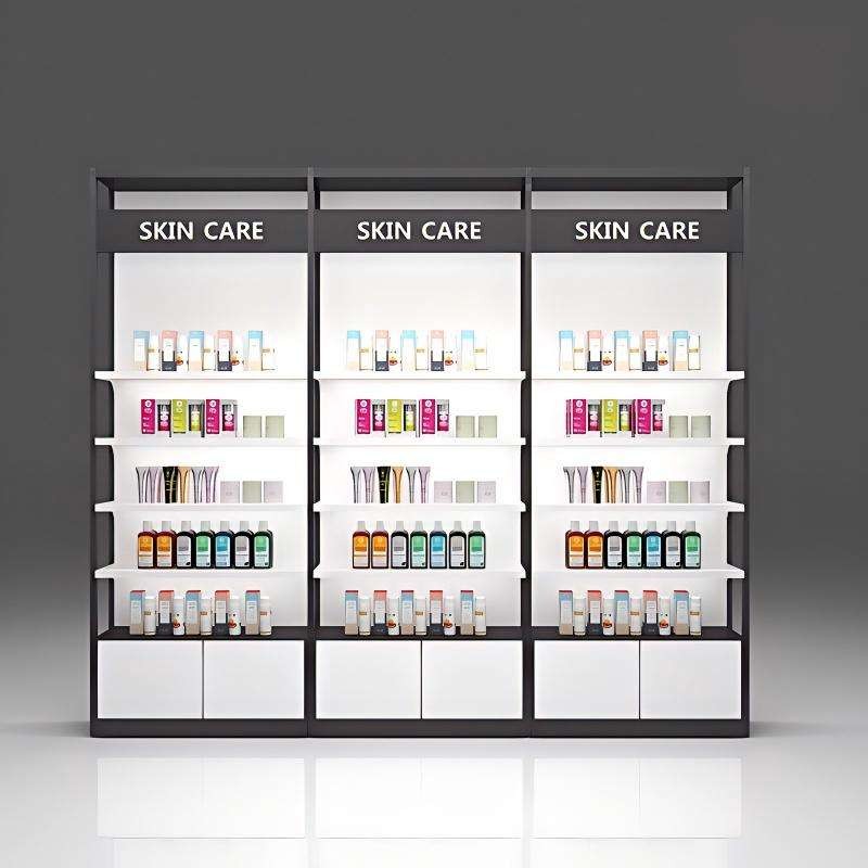 Cosmetics display DS-29, a three-bay illuminated wall-run skincare shelving system with black SKIN CARE header bands and white storage cabinets