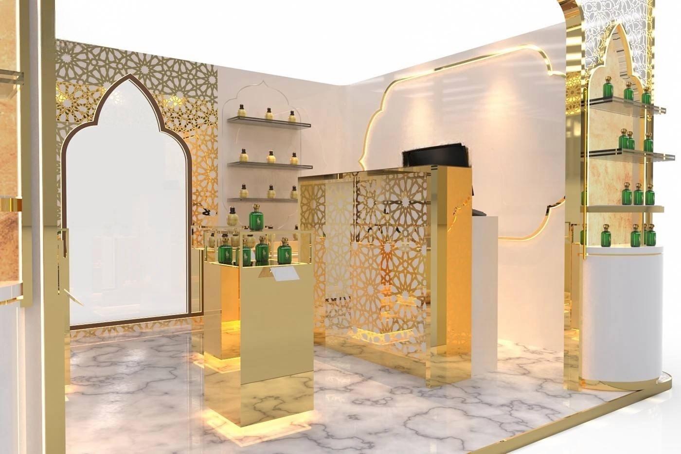 Backlit glass shelving and warm LED lighting inside a custom gold and white perfume kiosk interior